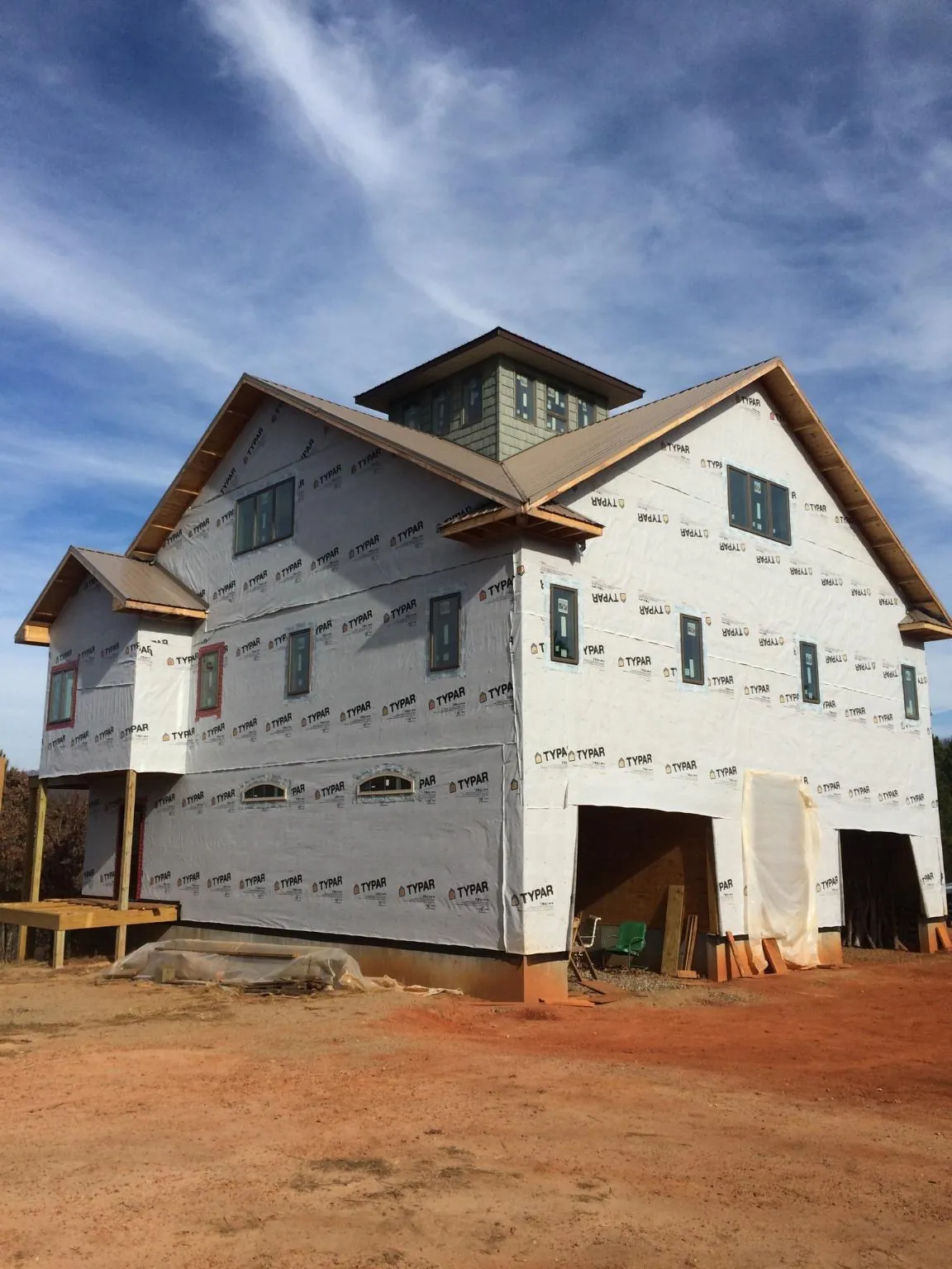 New two story house under construction with a cupola and gabled roofs in Salida